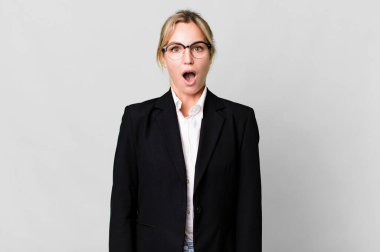 caucasian blonde woman looking very shocked or surprised. business concept