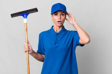 caucasian blonde woman looking happy, astonished and surprised. windows washer concept