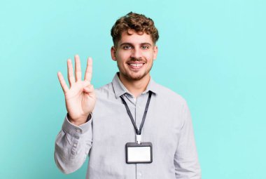 young adult caucasian man smiling and looking friendly, showing number four. blank accreditation pass card id concept