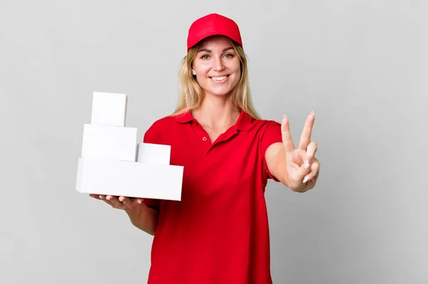 Caucasian Blonde Woman Smiling Looking Happy Gesturing Victory Peace Delivery — Stockfoto