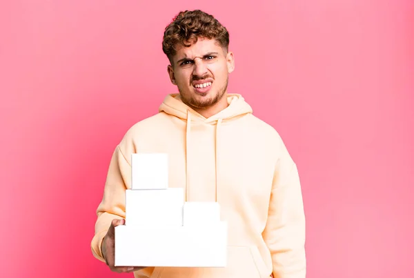 Young Adult Caucasian Man Feeling Puzzled Confused Blank Different Packages — Foto Stock