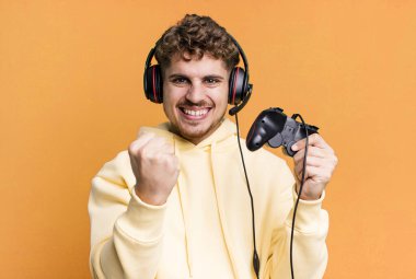 young adult caucasian man with headset and a controller. gamer concept