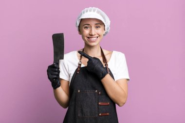 smiling cheerfully, feeling happy and pointing to the side. butcher concept