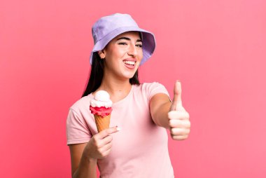 feeling proud,smiling positively with thumbs up. ice cream and summer concept