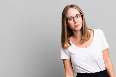 pretty blonde woman presenting a concept with a copy space