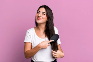 pretty hispanic woman using a hair comb