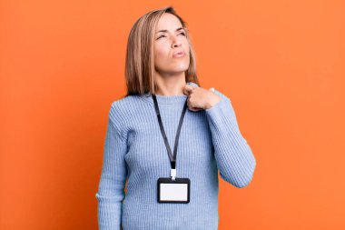 pretty blonde woman feeling stressed, anxious, tired and frustrated. with a blank vip pass id accreditation