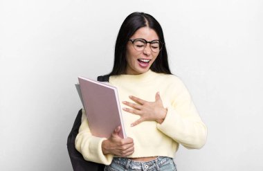 hispanic pretty woman laughing out loud at some hilarious joke. university student concept