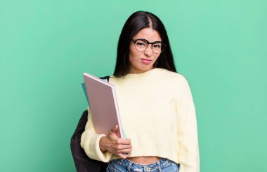 hispanic pretty woman feeling puzzled and confused. university student concept