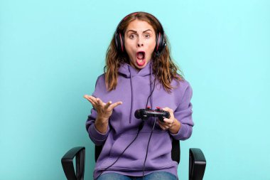 hispanic pretty woman amazed, shocked and astonished with an unbelievable surprise. gamer concept