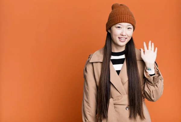Pretty Asian Woman Smiling Happily Waving Hand Welcoming Greeting You —  Fotos de Stock