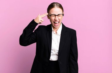 caucasian pretty woman looking unhappy and stressed, suicide gesture making gun sign. business concept