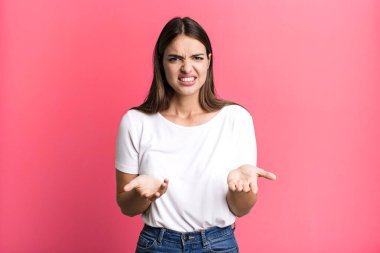 pretty young adult woman feeling clueless and confused, not sure which choice or option to pick, wondering