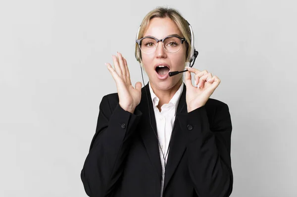 pretty caucasian blonde businesswoman real state agent with headset