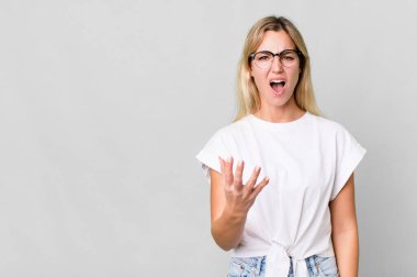 caucasian blonde woman looking angry, annoyed and frustrated. copy space concept