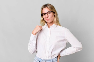 caucasian blonde woman looking arrogant, successful, positive and proud