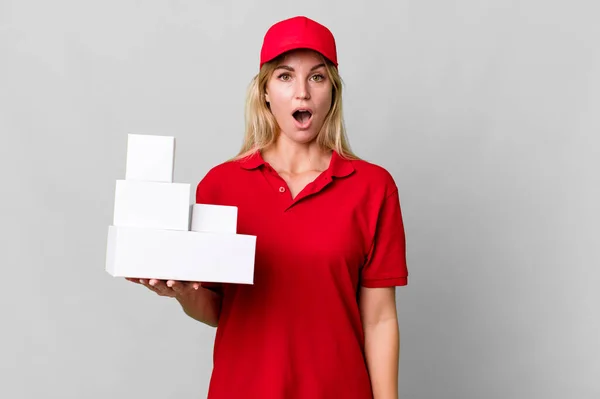 Caucasian Blonde Woman Looking Very Shocked Surprised Delivery Boxes — Stok fotoğraf