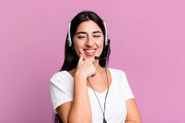 smiling with a happy, confident expression with hand on chin. telemarketer concept