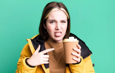 young pretty woman with a coat and a take away coffee