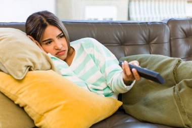 pretty latin woman relaxing and resting on a couch
