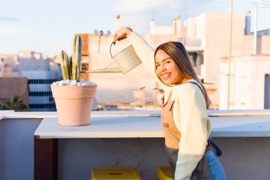 pretty latin woman gardering with a plant