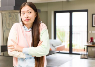 asian pretty woman at new home expressing an idea