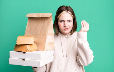 young pretty woman making capice or money gesture, telling you to pay. take away fast food concept