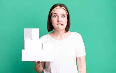young pretty woman looking puzzled and confused. white blank boxes