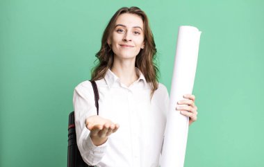 young pretty woman smiling happily with friendly and  offering and showing a concept. architect concept