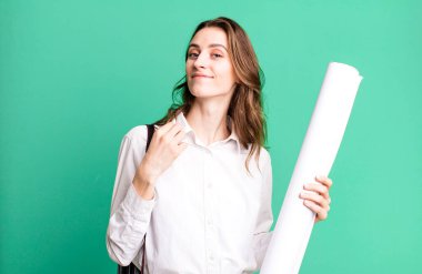 young pretty woman looking arrogant, successful, positive and proud. architect concept