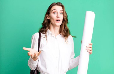 young pretty woman feeling extremely shocked and surprised. architect concept