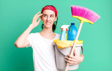young pretty woman feeling confused and puzzled, showing you are insane. housekeeper concept