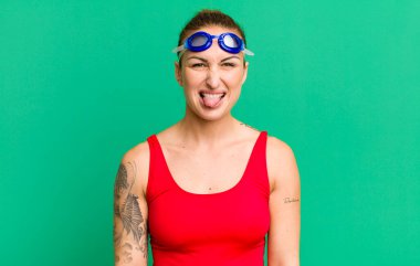 young pretty woman feeling disgusted and irritated and tongue out. swimmer concept