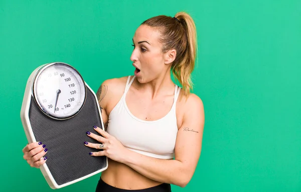 young pretty woman with a scale. diet and fitness concept
