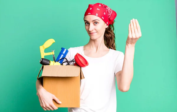 stock image young pretty woman making capice or money gesture, telling you to pay. housekeeper and toolbox concept