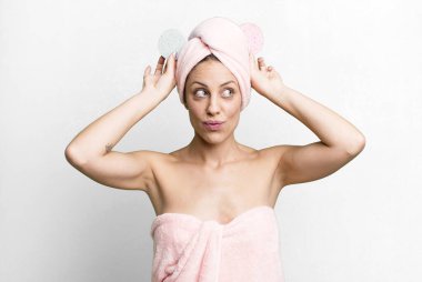 young pretty woman wearing bathrobe and making up concept