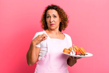 pretty middle age woman looking arrogant, successful, positive and proud. home made waffles concept