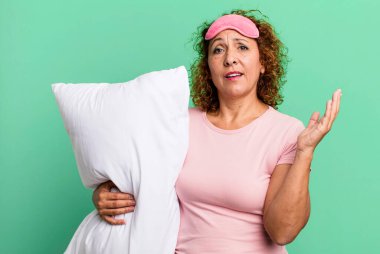 pretty middle age woman feeling happy, surprised realizing a solution or idea wearing pajamas night wear and a pillow