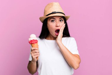 hispanic pretty woman feeling shocked and scared. ice cream and summer concept