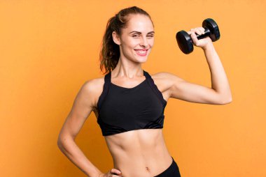 hispanic pretty young woman lifting a dumbbell. fitness concept