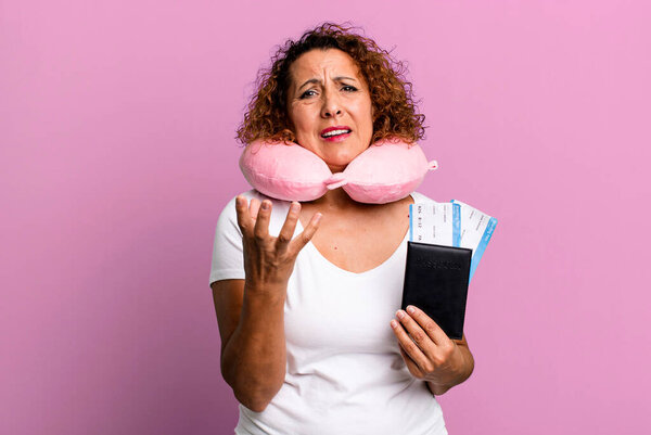 pretty middle age woman looking desperate, frustrated and stressed. flight passenger concept