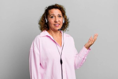 pretty middle age woman feeling happy, surprised realizing a solution or idea with a headset. telemarketing concept