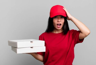 hispanic pretty woman looking happy, astonished and surprised. delivery pizza concept