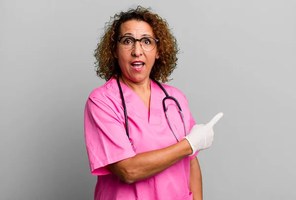 Pretty Middle Age Woman Looking Excited Surprised Pointing Side Nurse — Fotografia de Stock