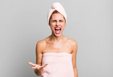 hispanic pretty woman looking angry, annoyed and frustrated wearing pbathrobe. beauty concept