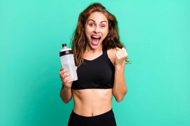 hispanic pretty woman feeling shocked,laughing and celebrating success. fitness and exercise concept