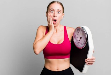 caucasian pretty woman feeling shocked and scared. fitness and diet concept