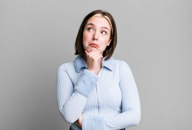 Düşünen, kuşkulu ve kafası karışık genç bir kadın.