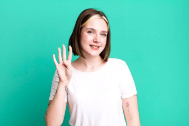 Genç, güzel bir bayan gülümsüyor ve arkadaş canlısı görünüyor.