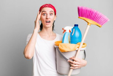 young pretty woman looking surprised, realizing a new thought, idea or concept. housekeeper concept